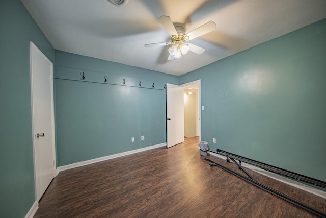 unfurnished bedroom featuring ceiling fan and dark hardwood / wood-style floors