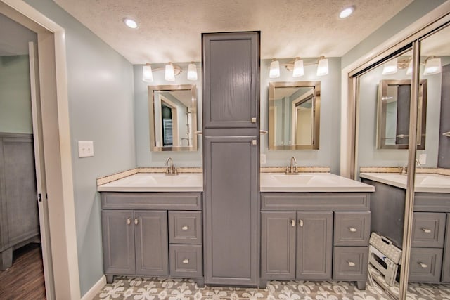 bathroom featuring vanity and a textured ceiling