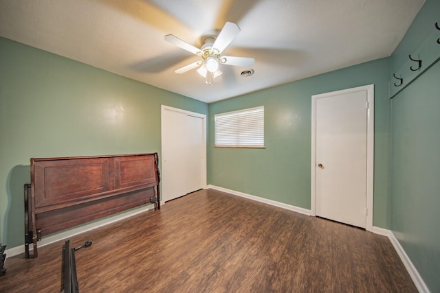 bedroom with ceiling fan and dark wood-type flooring