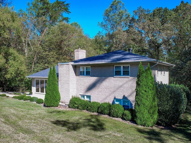 view of side of property with a lawn