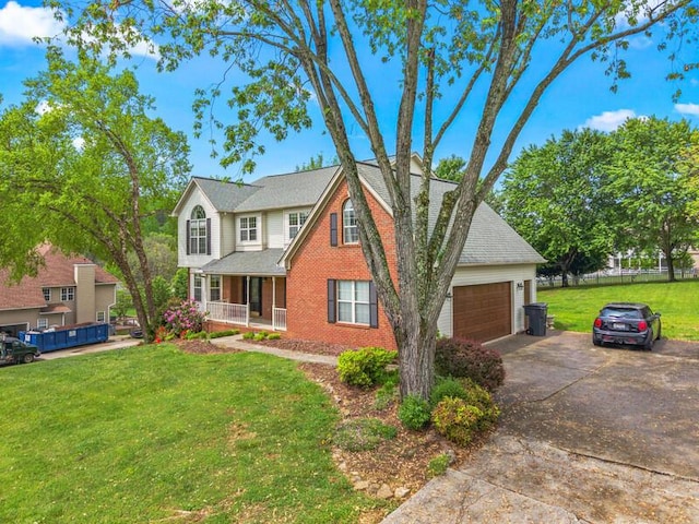 traditional-style home featuring an attached garage, a front lawn, brick siding, a porch, and driveway