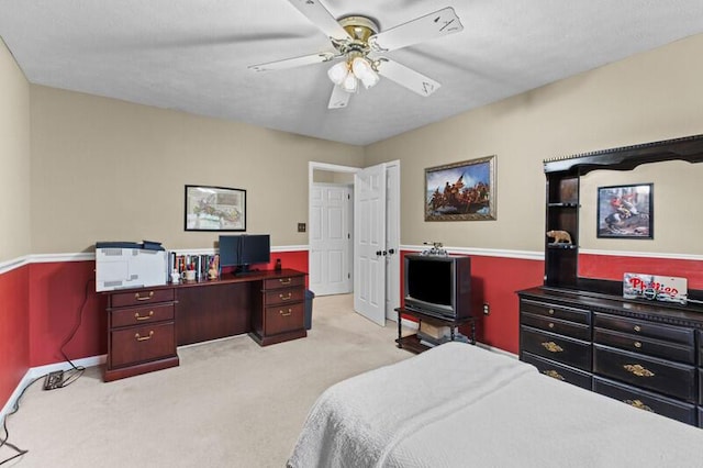 carpeted bedroom with baseboards and ceiling fan