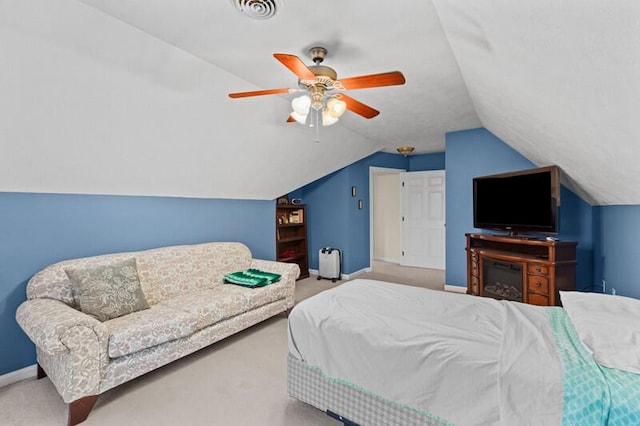 bedroom with a ceiling fan, visible vents, vaulted ceiling, carpet floors, and baseboards