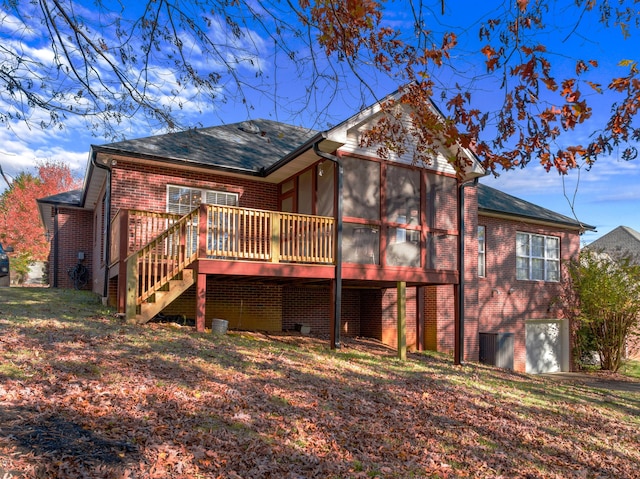 back of house with a wooden deck and a sunroom