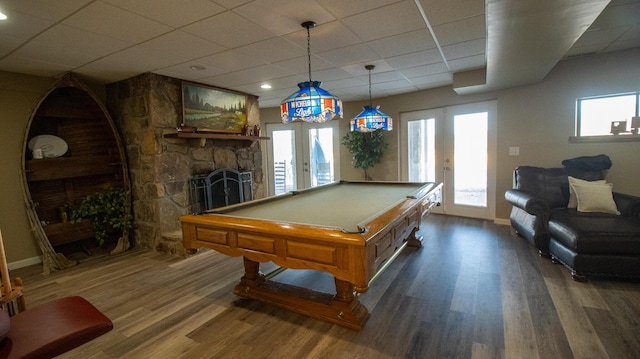 rec room with a fireplace, billiards, dark hardwood / wood-style flooring, a drop ceiling, and french doors