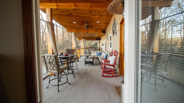 sunroom with vaulted ceiling and wood ceiling