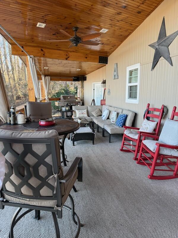 view of patio with outdoor lounge area and ceiling fan