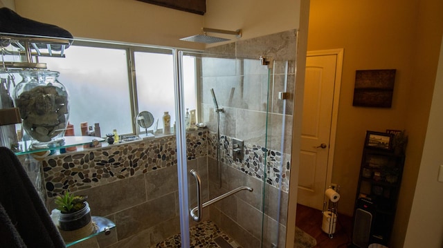 bathroom with a shower with shower door