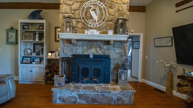 living room with hardwood / wood-style flooring and a wood stove