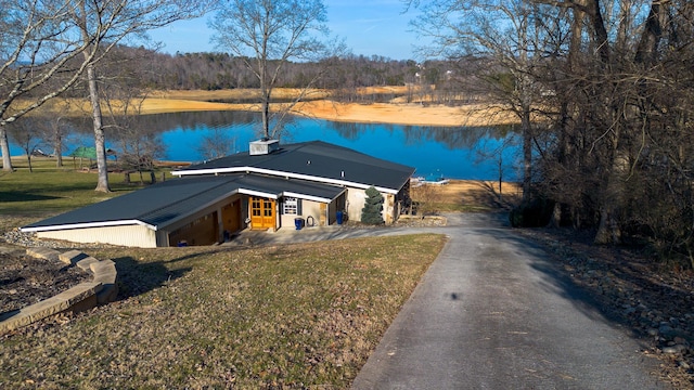 exterior space with a water view and a front lawn