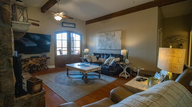 living room featuring ceiling fan, wood-type flooring, and vaulted ceiling with beams