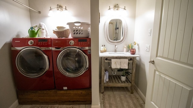 clothes washing area featuring separate washer and dryer and sink