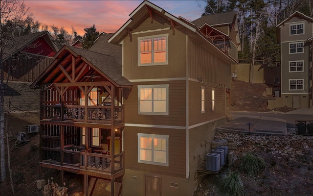 back house at dusk with central AC unit