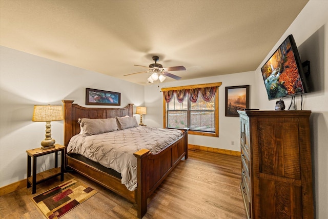 bedroom with ceiling fan and light hardwood / wood-style floors