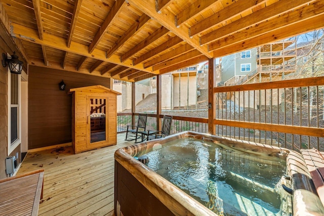 wooden deck featuring a hot tub