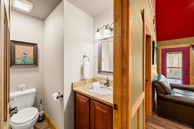 bathroom featuring hardwood / wood-style floors, vanity, and toilet