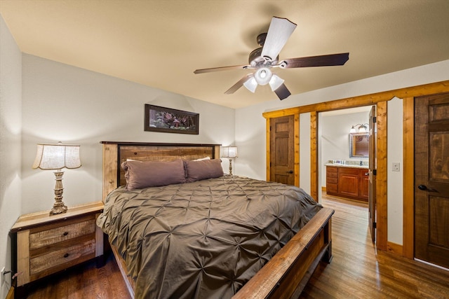 bedroom with ceiling fan, dark hardwood / wood-style floors, and connected bathroom