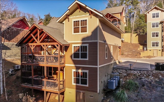 rear view of property with cooling unit