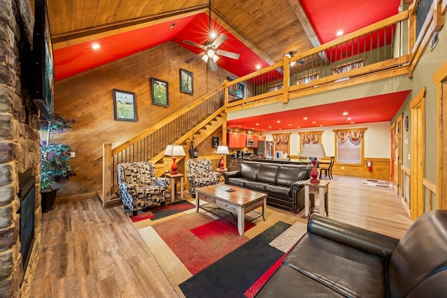 living room with ceiling fan, high vaulted ceiling, hardwood / wood-style floors, wooden walls, and wood ceiling