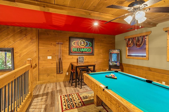 game room featuring wooden walls, ceiling fan, hardwood / wood-style flooring, and pool table