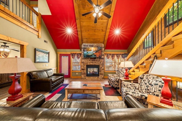 living room featuring a fireplace, wood-type flooring, and high vaulted ceiling