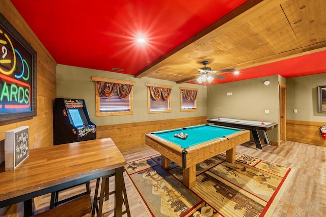 game room featuring ceiling fan, beamed ceiling, billiards, wood walls, and wood-type flooring