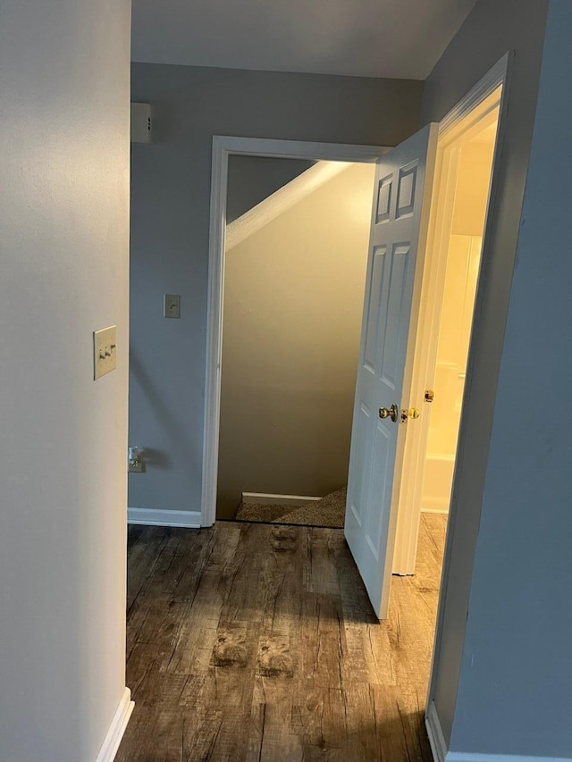 hallway with hardwood / wood-style flooring