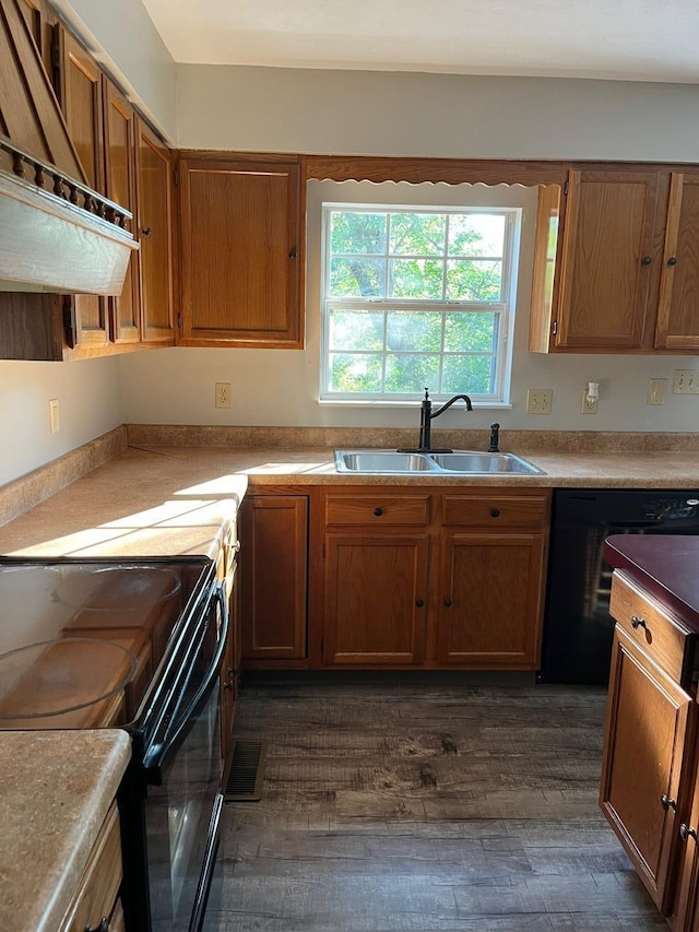 kitchen featuring custom range hood, black appliances, dark hardwood / wood-style floors, and sink