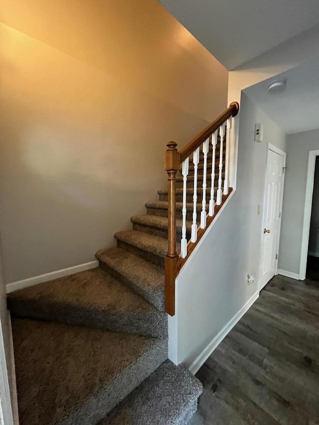 stairs featuring hardwood / wood-style floors