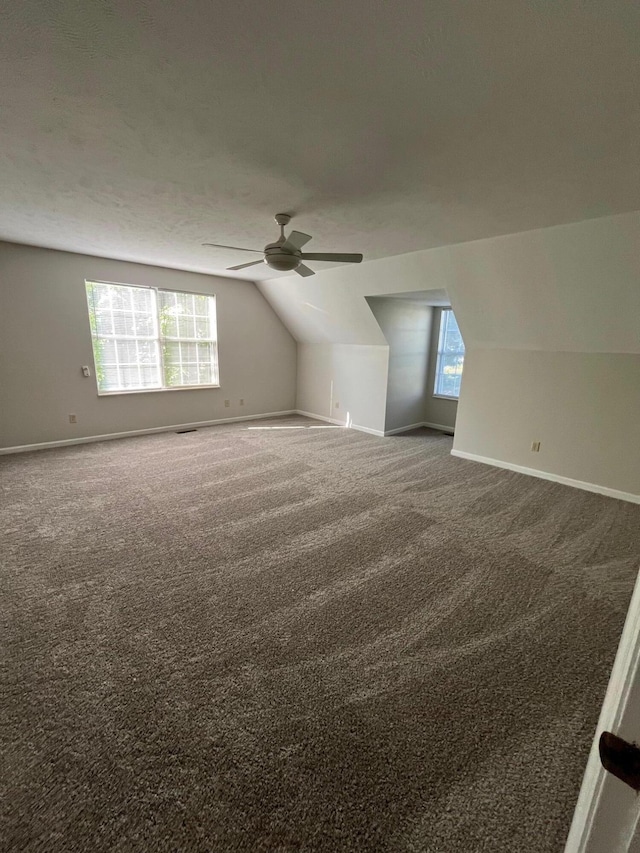 additional living space with ceiling fan, carpet flooring, and vaulted ceiling