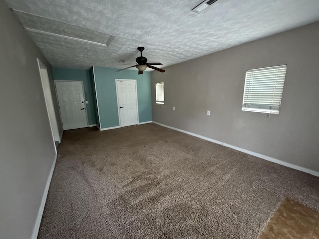 empty room with baseboards, attic access, carpet floors, and visible vents