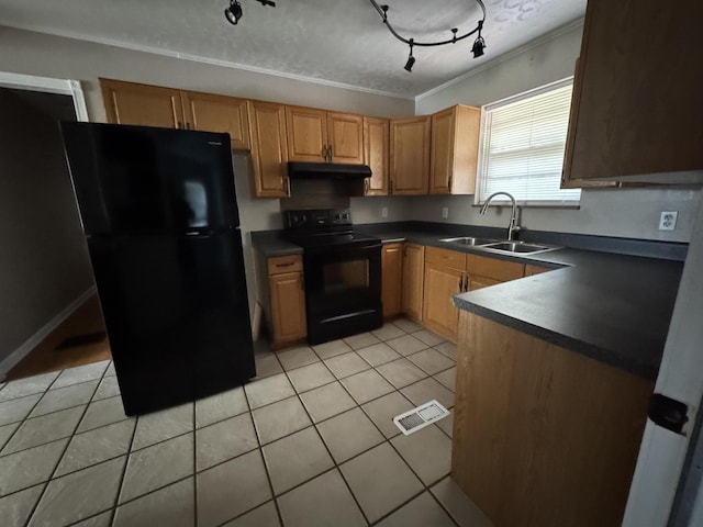 kitchen featuring light tile patterned flooring, dark countertops, a sink, under cabinet range hood, and black appliances