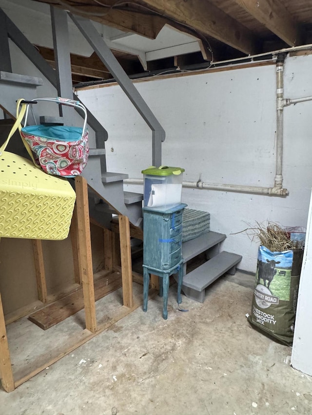 unfinished below grade area featuring stairway