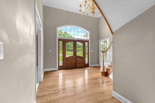 1647 Talon Ct, Talbott, TN 37877 - foyer entrance with a chandelier, stairs, light wood-type flooring, baseboards, and french doors