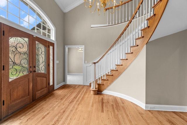1647 Talon Ct, Talbott, TN 37877 - foyer featuring stairs, wood finished floors, a towering ceiling, a chandelier, and baseboards