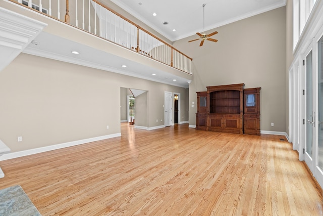 1647 Talon Ct, Talbott, TN 37877 - unfurnished living room featuring a towering ceiling, a ceiling fan, crown molding, light wood-style floors, and baseboards