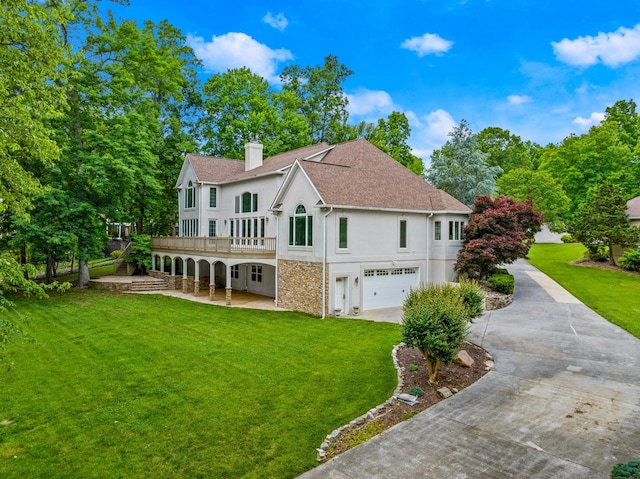 1647 Talon Ct, Talbott, TN 37877 - rear view of house with concrete driveway, an attached garage, a yard, and a chimney