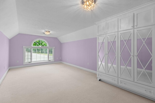 1647 Talon Ct, Talbott, TN 37877 - additional living space with vaulted ceiling, baseboards, light colored carpet, a chandelier, and a textured ceiling