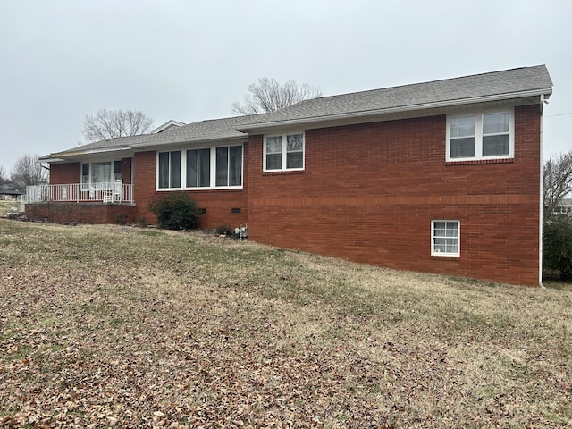 view of side of home featuring a yard