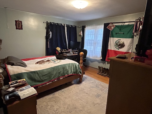 bedroom with hardwood / wood-style flooring