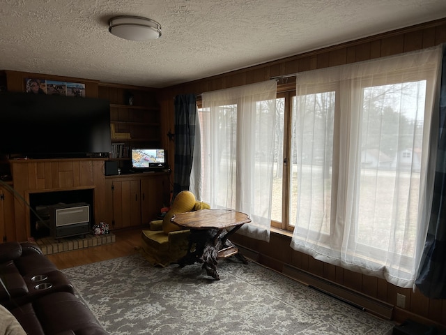 living room with a textured ceiling and wooden walls