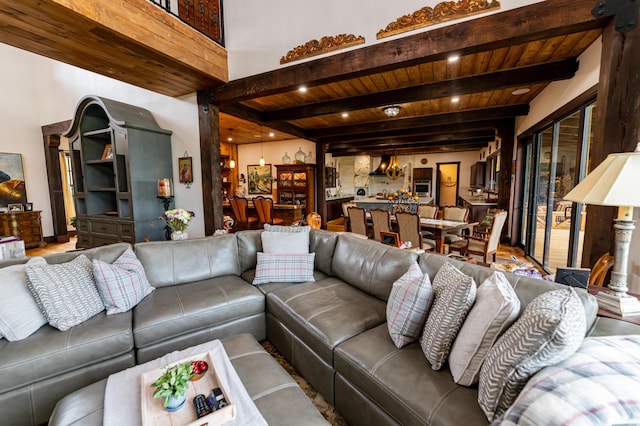 living room featuring beamed ceiling and wooden ceiling