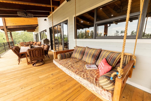 sunroom / solarium featuring beamed ceiling and wood ceiling