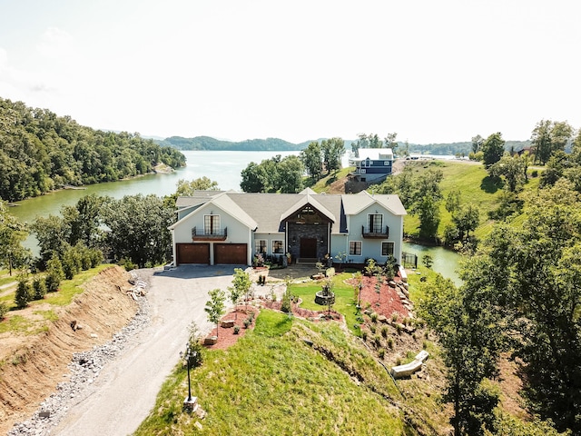 view of front of property featuring a water view and a garage