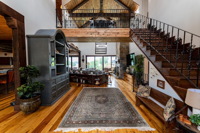 interior space featuring beamed ceiling, high vaulted ceiling, wood ceiling, and hardwood / wood-style flooring