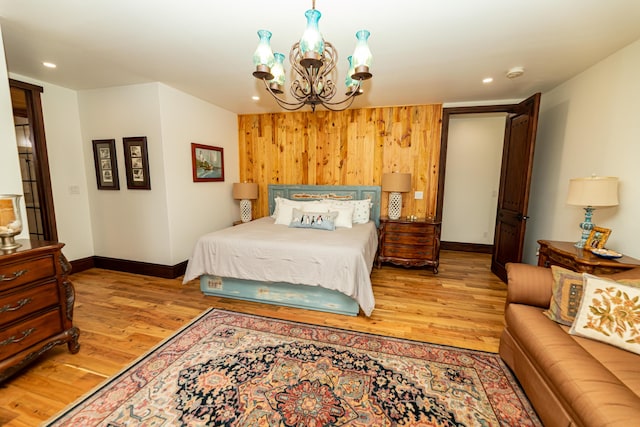 bedroom featuring light wood-type flooring and an inviting chandelier