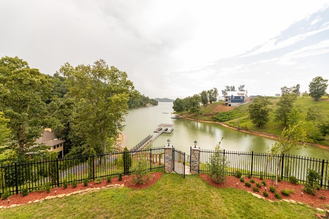 view of yard featuring a water view and a boat dock