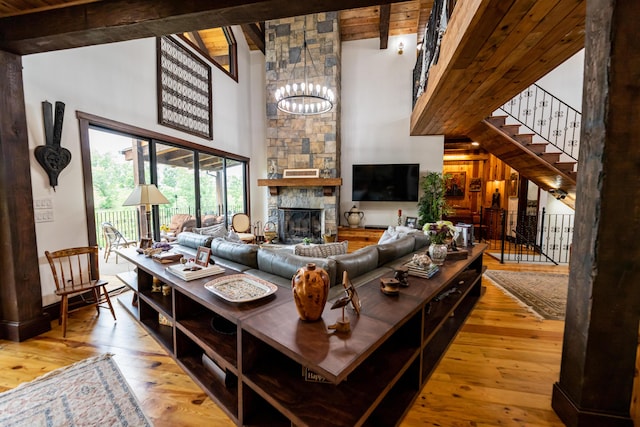 living room with hardwood / wood-style floors, wooden ceiling, high vaulted ceiling, an inviting chandelier, and beamed ceiling