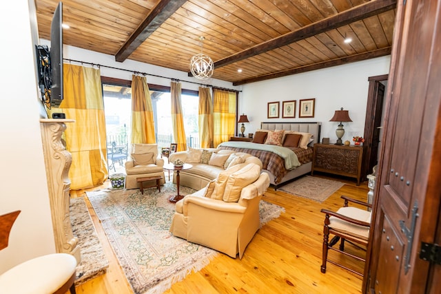 bedroom with beam ceiling, light hardwood / wood-style floors, and wood ceiling