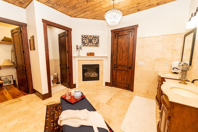 bathroom featuring vanity, wood ceiling, a notable chandelier, and toilet